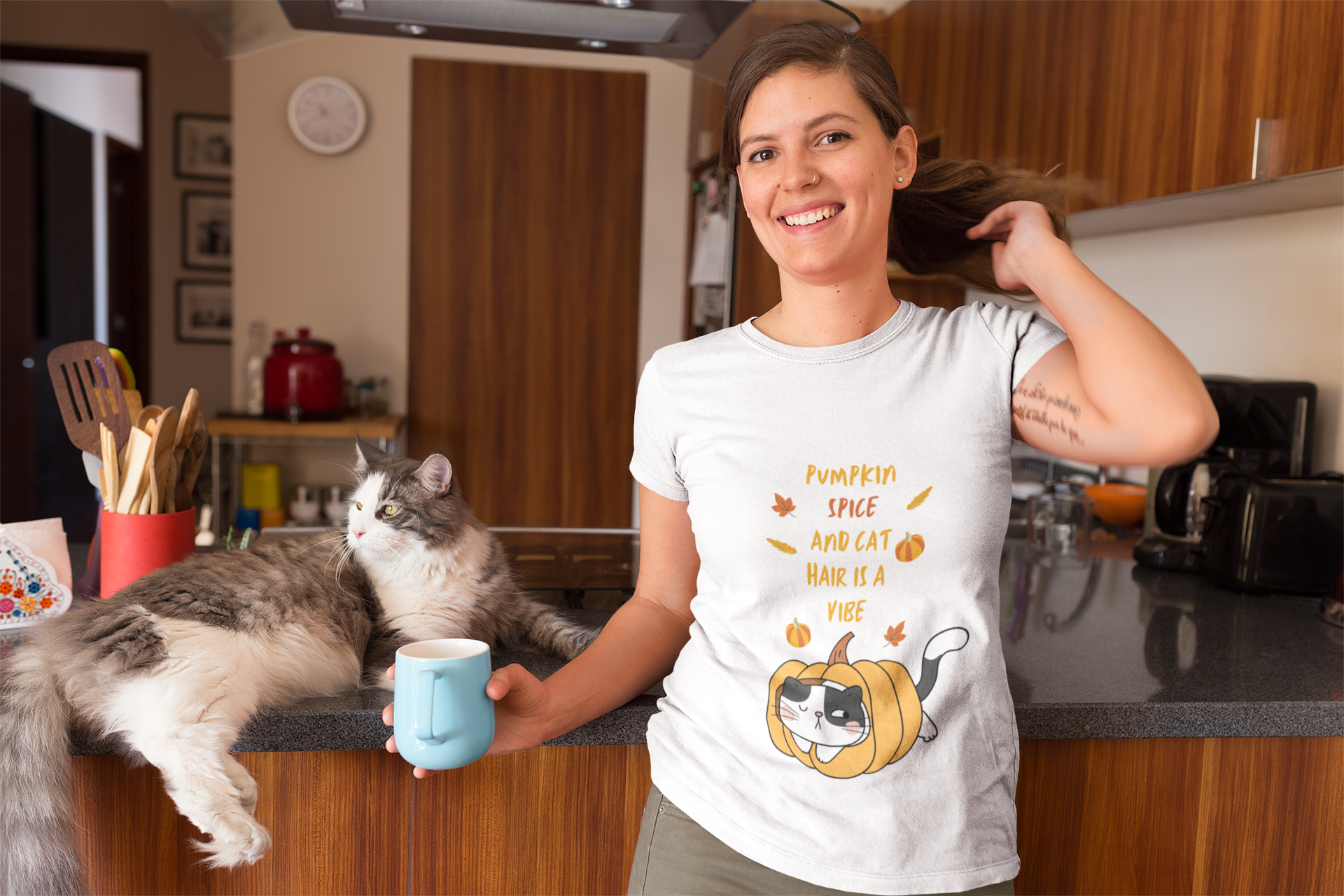 happy-woman-wearing-a-t-shirt-mockup-with-her-cat-at-the-kitchen-a18971.png