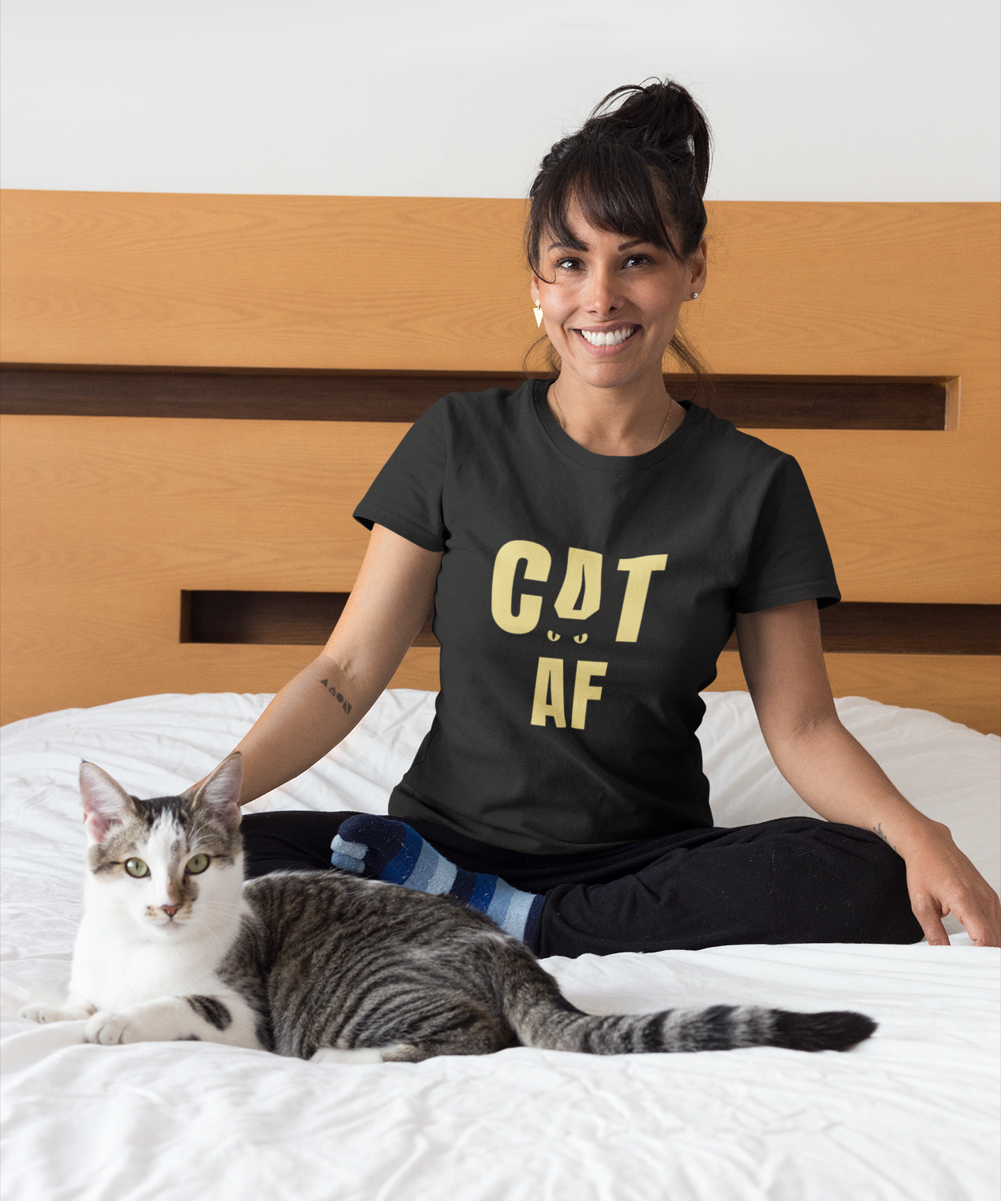 portrait-of-a-happy-cat-owner-wearing-a-t-shirt-mockup-on-bed-a18790.png